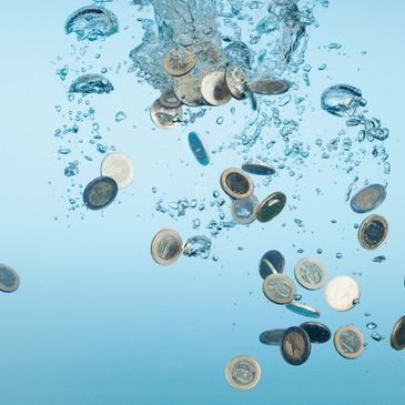 Coins falling through water, representing the cost of training